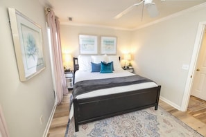 Coastal-themed bedroom with a King bed, bedside dressers, thoughtfully curated accessories, art, and a ROKU TV. Serene ambiance with beachy vibes. Relax and stream your favorite shows! 