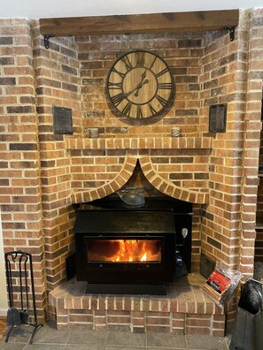 Wood stove fireplace in living room #1.