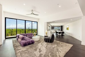 Transport yourself to the 90s with the nostalgic furniture adorning this open-concept living space, perfectly complemented by sliding doors that invite in natural light.