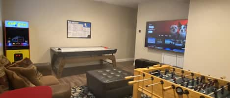 Game room with air hockey, foosball, arcade, chess table and a 75" Smart TV!