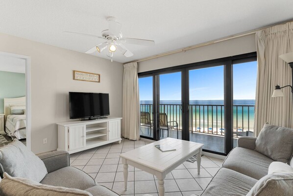 Coastal comfort from your air conditioned iving room with balcony access