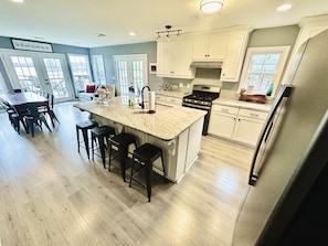 Fully stocked kitchen has new granite, island seating, and a great lakeview! 