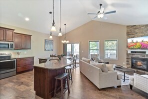 Vaulted Great Room opens to kitchen and upper deck