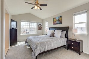 Upstairs master bedroom with Roku TV, ceiling fan and plenty of natural sunlight