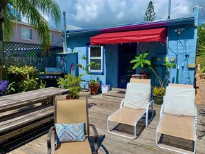 Back patio lounge / dining area with gas grille. 