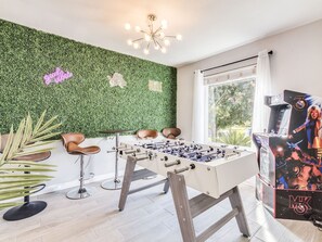 Entertainment space with Arcade, Bar table and stools and Foosball