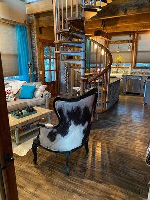 Living space & kitchen w/spiral staircase which leads to loft bedroom.