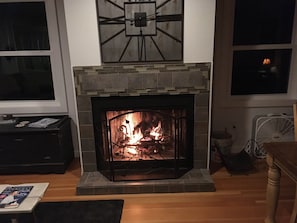 A cozy wood fire for your enjoyment. A cedar mantel was added in 2021.