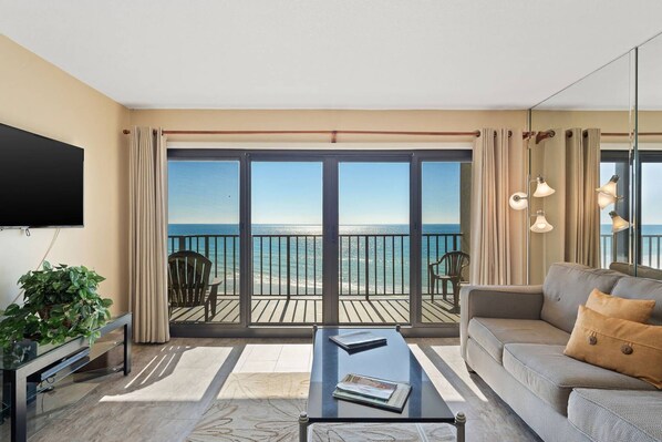 Living room area with sleeper sofa and gulf view.