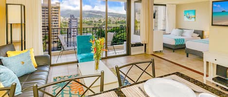 Living room with a reclining sleeper sofa, chair TV and cable. Enjoy beautiful mountain and city views from the living room