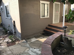 The cottage is on the rear of a two house property 