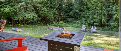 Firepit with 2 Adirondack chairs.. This portion of the deck is covered 