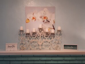 Decorative Fireplace Mantle with Candleabra and Orchid Wall Decor