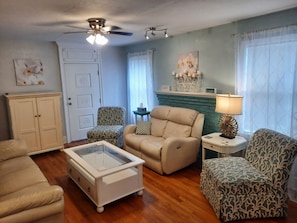 Living Room 1 with Leather Couch and loveseat, 2 accent chairs, end tables, TV