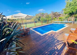 Fully gated solar-heated pool overlooking the tennis court and rugged bush land 