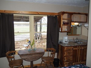 MAIN ROOM:  The little sink / kitchenette and breakfast table that is in the main room.