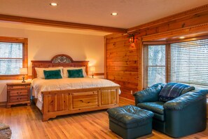 First bedroom with second gas fireplace and king bed.