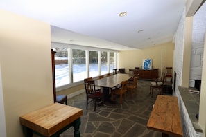 Front dining room with windows looking into the front yard. Double opening fireplace.