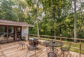 Back deck with grill, outdoor seating and dining, and firepit. Overlooks the backyard and the creek below. 