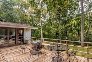 Back deck with grill, outdoor seating and dining, and firepit. Overlooks the backyard and the creek below.
