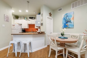 Dining and kitchen space with new bar stools and decor throughout