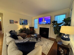 living room with flatscreen TV and electric fireplace