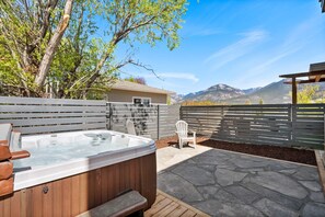 Private hot tub in the backyard with mountain views.