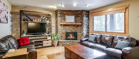 Cozy fireplace and living area with beautiful mountain view from the window