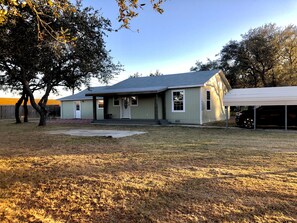 Fenced in yard with covered carport