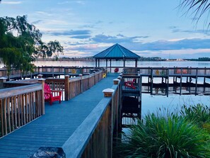 Covered pavilion at the lake on the boardwalk with chairs to relax and fishing