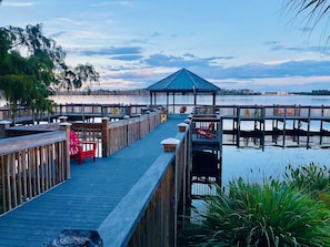 Covered pavilion at the lake on the boardwalk with chairs to relax and fishing