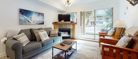 Living room w/ queen sofa bed, gas fireplace, and cable TV