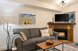 Cosy living room with queen sofa bed, gas fireplace and cable TV