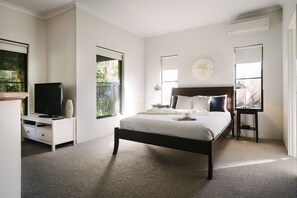 Retreat to the serene comfort of the primary suite, featuring a queen bed and a walk-in wardrobe, providing plenty of space to unpack.