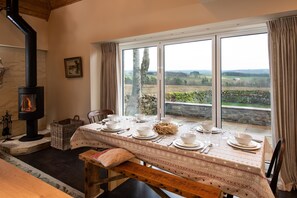 The Bothy at Redheugh - dining area with bi-fold doors to the patio area