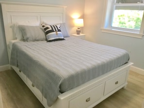 Front bedroom with queen bed and walkin closet