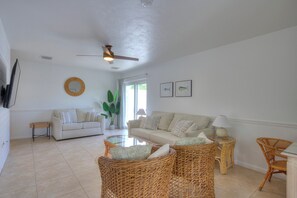 Living room with pull out queen sofa bed, love seat and two club chairs. 