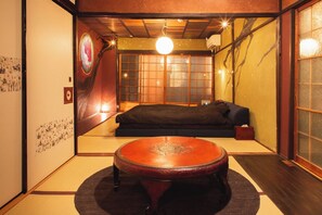 An open bedroom / living room with a wide king bed