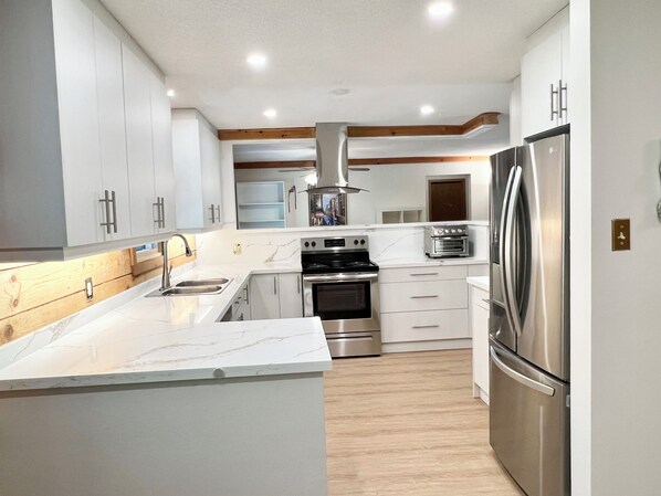 Large renovated Kitchen with electric stove/oven, toaster/fryer, coffee machine