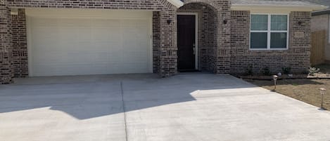 House frontage with several cars parking space 