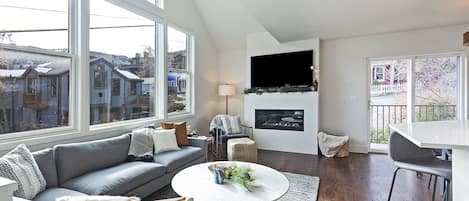 Living Room with plenty of seating, big screen TV and fireplace.