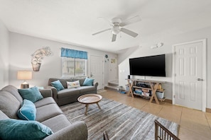Family Room - 65 Inch 4k TV w/ Cable, Streaming, and a Blue Ray Player.