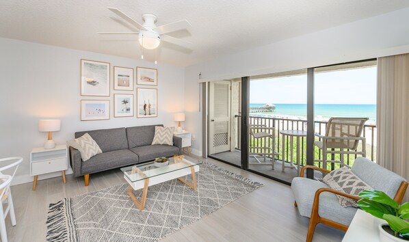 Bright and modern living area with a stunning ocean view and stylish decor.