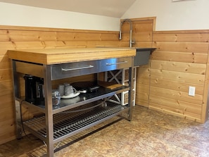 Kitchenette with sink, air fryer, hot plate, dishes, utensils, French press