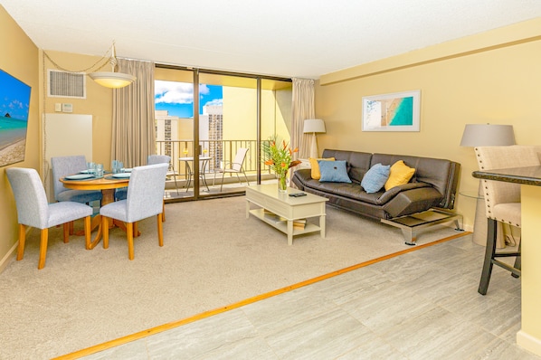 Living room with a reclining sleeper sofa, dining table for 4, open kitchen, SMART TV, central air