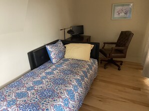 Second bed (single) and a work space 