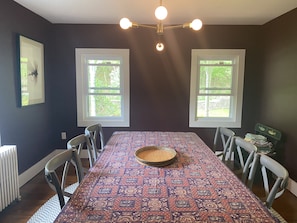 Dining Room!  8 Chairs, Eggplant Walls, and lots of windows.