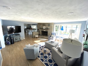 Spacious LR with wood fireplace, 60” TV and cable.