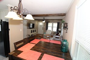 Dining table off of living area and kitchen