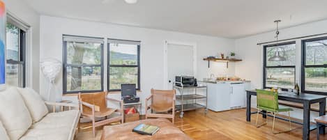 Studio cabins featuring a cozy living room flowing into the kitchen/dining area 